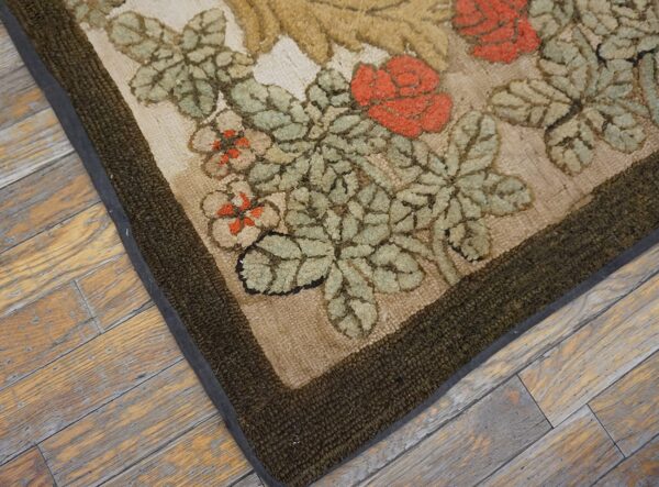 Close-up of the floral pattern corner of the hooked floral rug by rugs on net. By rugs on net