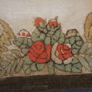 Close-up of a hooked rug featuring vibrant red roses and green foliage against a light background, by Rugs On Net. by Rugs On Net