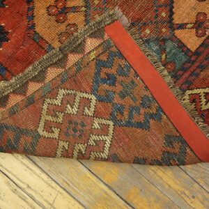 Close-up of the backing and fringe of a richly colored tribal rug by Rugs On Net. by Rugs On Net