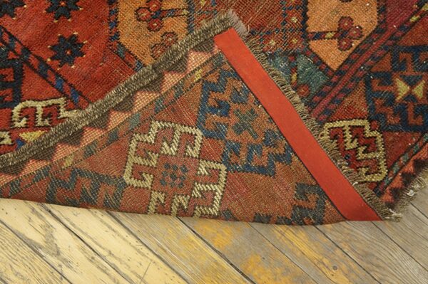 Close-up of the backing and fringe of a richly colored tribal rug by rugs on net. By rugs on net