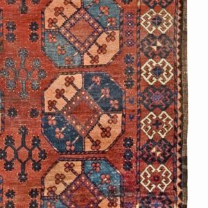 Close-up of a richly colored rug with geometric motifs in red, blue, and tan by Rugs On Net. by Rugs On Net