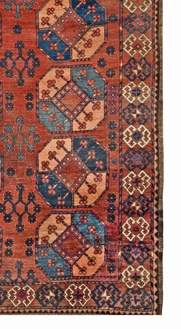 Close-up of a richly colored rug with geometric motifs in red, blue, and tan by rugs on net. By rugs on net