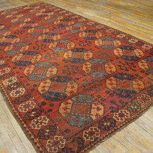 Close-up view of a richly colored, geometric patterned rug on a light wood floor by Rugs On Net