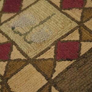 Close-up texture shot of a geometric pattern rug in earthy tones by Rugs On Net