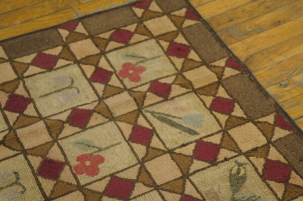 Close-up of a hooked rug with a geometric pattern and floral motifs, by rugs on net