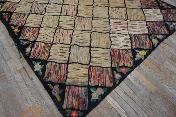 Close-up of a colorful checkerboard rag rug with floral border on wood floor by rugs on net
