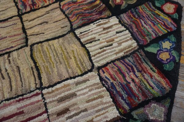 Close-up of a colorful, patchwork hooked rug with varied textures and floral accents by rugs on net. By rugs on net