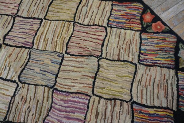 Close-up of a colorful, patchwork hooked rug with abstract squares by rugs on net. By rugs on net