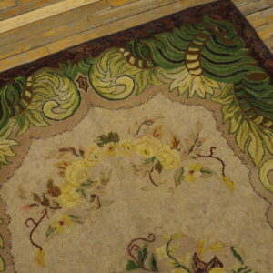 Close-up of a floral rug with green vine border on wooden floor by Rugs On Net