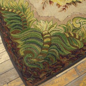 Close-up of a hooked rug border featuring lush green foliage patterns on a dark brown edge, by Rugs On Net