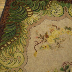 Close-up of a hooked rug featuring green foliage border and yellow floral center on a tan field, by Rugs On Net. by Rugs On Net