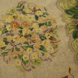 Close-up of a beige rug featuring a central bouquet of yellow and orange flowers with green leaves, part of the 'Floral Bouquet Hooked Rug' by Rugs On Net. by Rugs On Net
