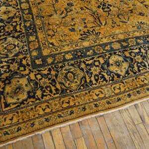 Close-up of a richly patterned gold and navy rug border by Rugs On Net. by Rugs On Net