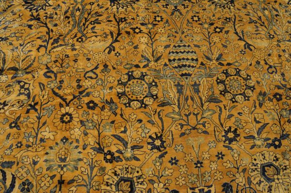 Close-up of a gold and navy floral rug pattern by rugs on net. By rugs on net