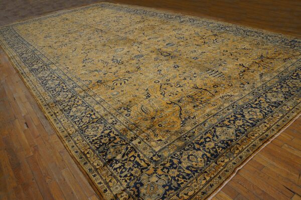 Large antique rug with gold and navy floral patterns by rugs on net. By rugs on net
