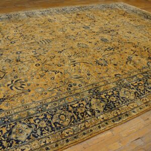 Close-up of a large, antique gold and navy blue floral Persian rug by Rugs On Net. by Rugs On Net