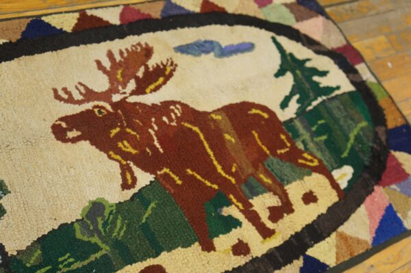 Close-up of a hooked rug featuring a large brown moose against a cream background, by rugs on net. By rugs on net
