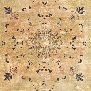 Close-up of a faded, antique-style rug with an olive-green field and black floral motifs by Rugs On Net. by Rugs On Net