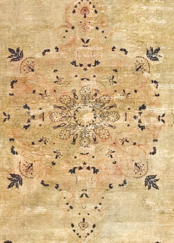 Close-up of a faded, antique-style rug with an olive-green field and black floral motifs by rugs on net. By rugs on net
