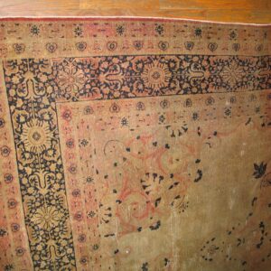Close-up of the worn border and field of a traditional rug by Rugs On Net