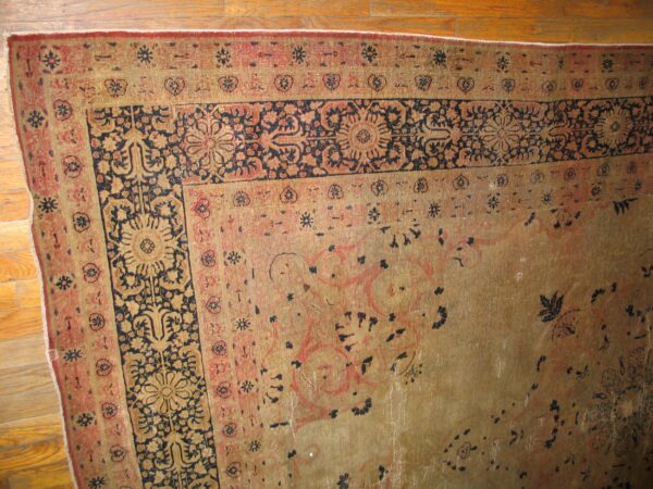 Close-up of the worn border and field of a traditional rug by rugs on net