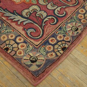 Close-up corner detail of a richly colored, floral hooked rug on wooden flooring by Rugs On Net. by Rugs On Net