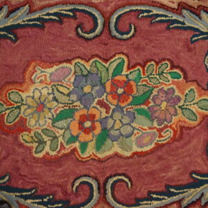 Close-up of a colorful floral medallion on a deep pink background of the Hooked Rug by Rugs On Net. by Rugs On Net