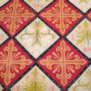 Close-up of a tapestry rug featuring repeating diamond patterns in red and cream with stylized crosses and floral motifs, by Rugs On Net. by Rugs On Net