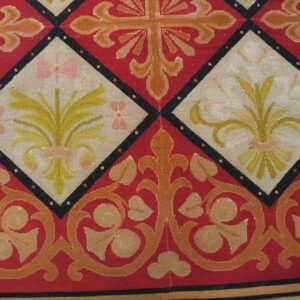 Close-up of a red and cream tapestry rug featuring diamond medallions with floral motifs, by Rugs On Net
