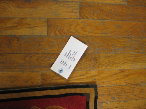 Close-up of the tag for rug #19057 needlepont by rugs on net. By rugs on net