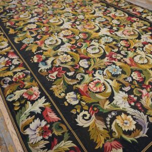 Close-up of a dark Aubusson rug with vibrant floral and foliage patterns, by Rugs On Net