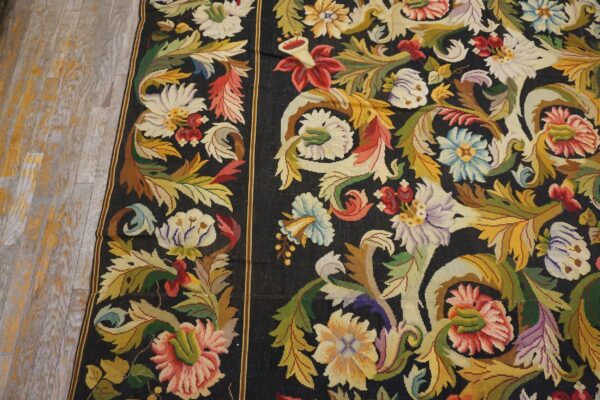 Close-up of a vibrant floral needlepoint rug with a black background by rugs on net