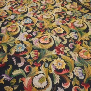 Close-up of a dark background rug featuring vibrant, dense floral and foliate patterns in yellow, red, blue, and green by Rugs On Net