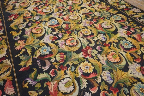 Close-up of a dark aubusson rug with vibrant floral and acanthus leaf motifs by rugs on net. By rugs on net