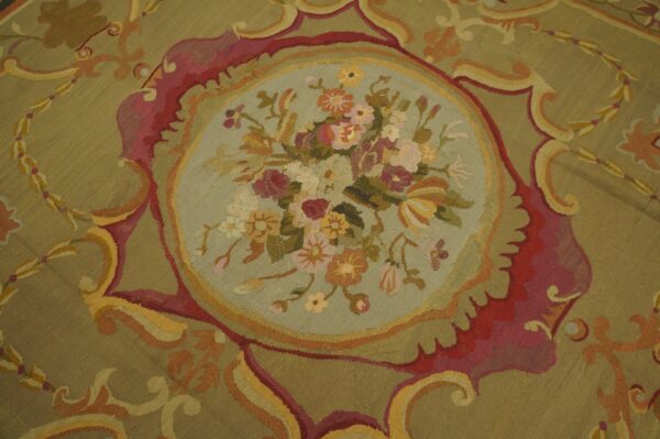 Close-up of a tapestry rug featuring a central floral medallion on a sage background, by rugs on net
