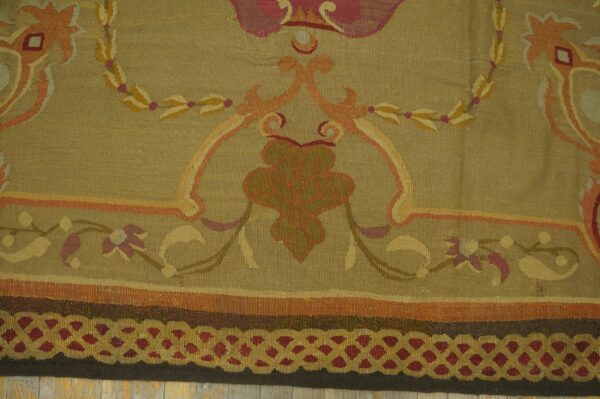 Close-up of a tapestry rug featuring olive green field with scrolling floral motifs in peach and gold, by rugs on net