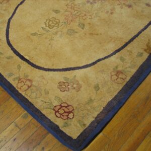 Close-up of a gold floral rug corner with a dark border by Rugs On Net