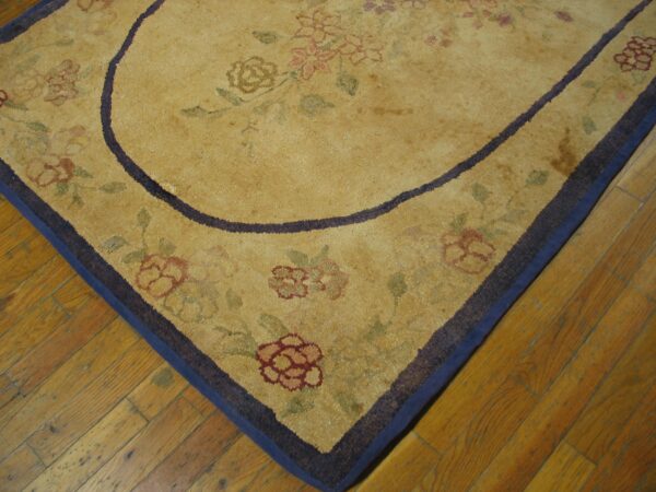Close-up of a gold floral rug corner with a dark border by rugs on net