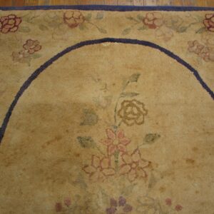 Close-up of an aged, tan floral rug with a dark border detail by Rugs On Net