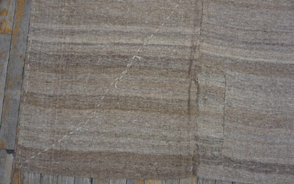 Close-up texture of a natural brown striped kilim rug by rugs on net. By rugs on net