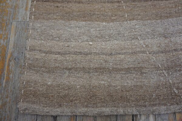 Close-up of the natural fiber texture of the neutral striped kilim rug by rugs on net. By rugs on net