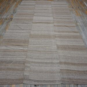 Striped beige kilim rug on weathered wood floor by Rugs On Net