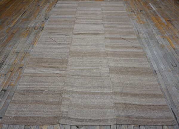 Striped beige kilim rug on weathered wood floor by rugs on net