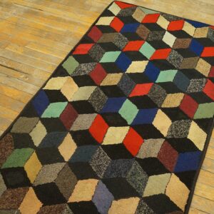 A geometric rug featuring a 3D cube pattern in various colors against a black background, by Rugs On Net. by Rugs On Net