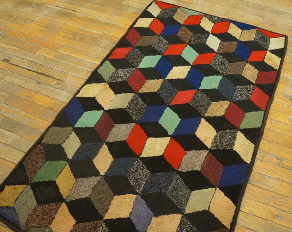 A geometric rug featuring a 3d cube pattern in various colors against a black background, by rugs on net. By rugs on net