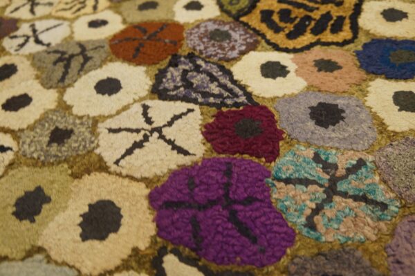 Close-up of a colorful hooked rug with abstract floral shapes, by rugs on net