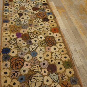 A colorful hooked rug with abstract floral shapes on a wooden floor by Rugs On Net