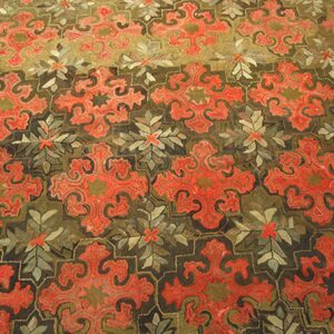Close-up of a richly patterned rug featuring bold, stylized red medallions on a dark olive ground by Rugs On Net. by Rugs On Net
