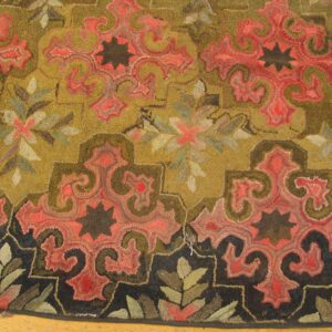 Close-up of a richly colored hooked rug featuring olive green and deep coral paisley motifs against a gold field, with a dark border by Rugs On Net. by Rugs On Net