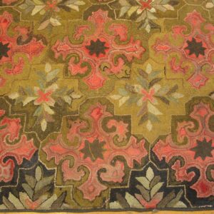 Close-up of a hooked rug featuring olive green and coral paisley motifs with dark accents by Rugs On Net. by Rugs On Net